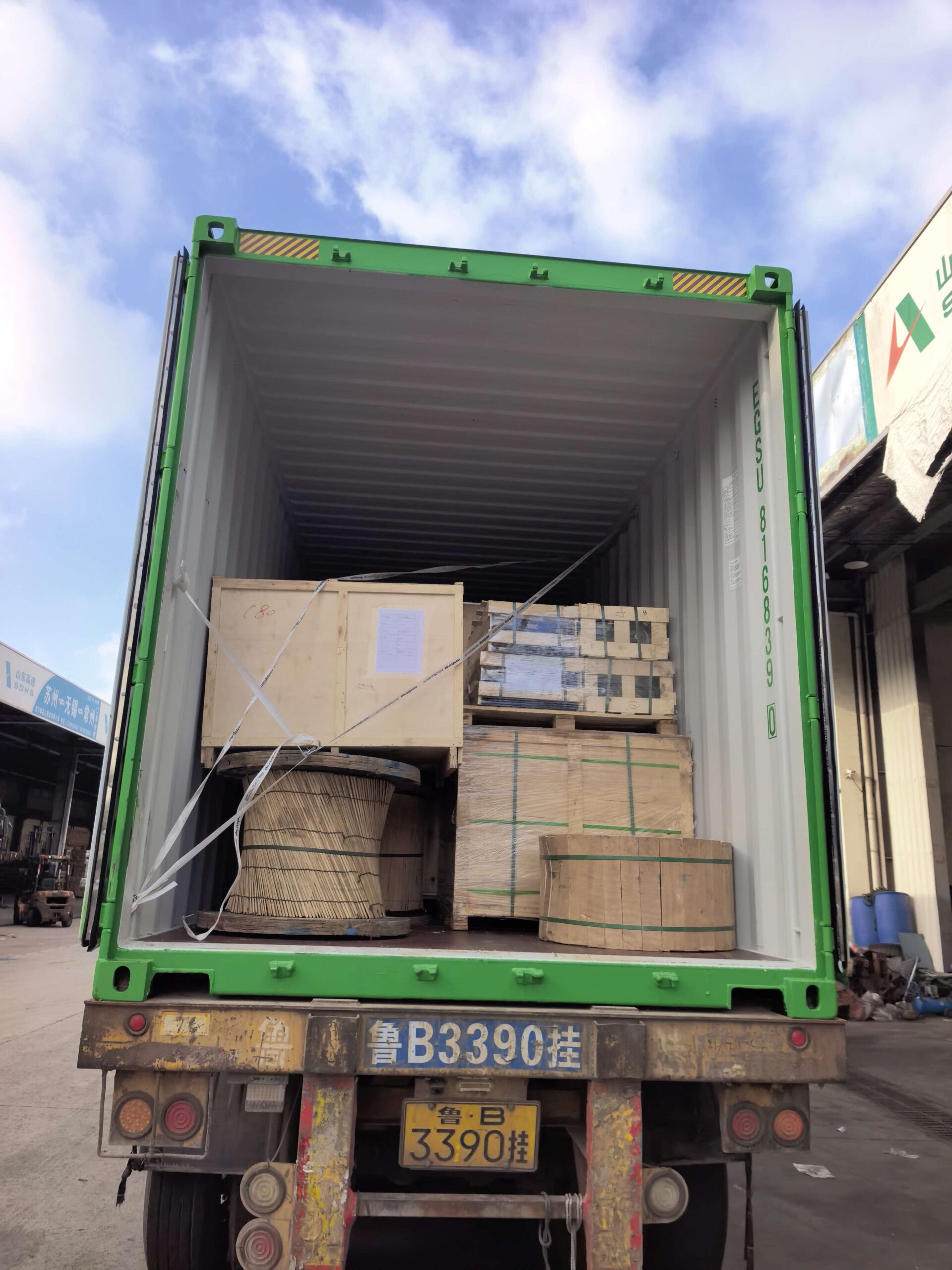 Electrical equipment crates and conductor drum secured inside a container for shipment to Burundi